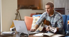 Man Playing Guitar with Inspiron 15 5000 Series Notebook