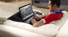 Man Sitting on Couch Using an Inspiron 17 5000 Series Touch Note